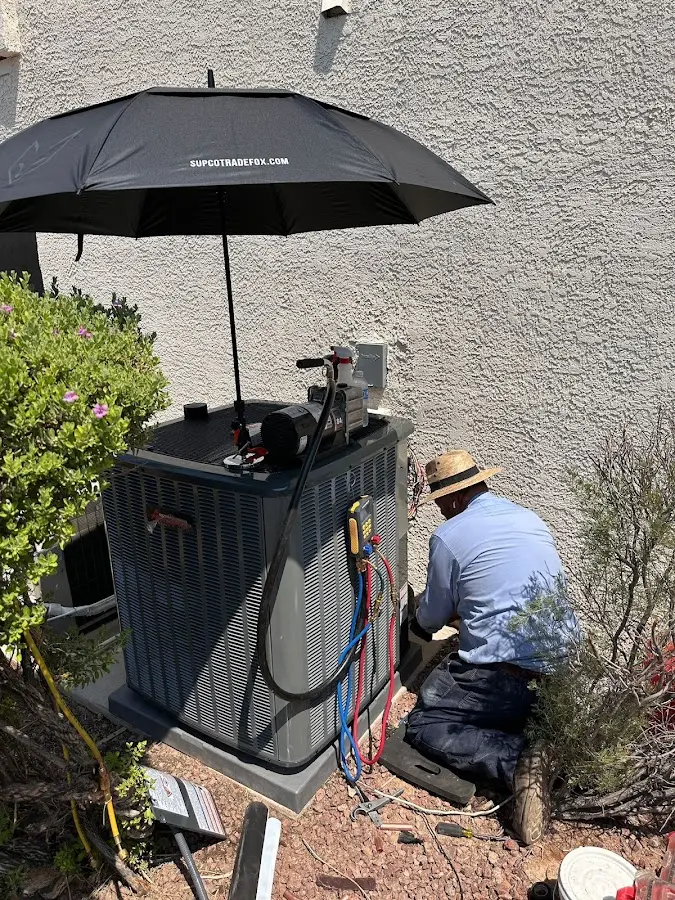 HVAC technician performing outdoor AC maintenance in Atoka